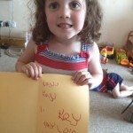 Learning to write her name unaided
